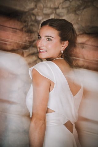 Portrait de dos de la mariée dévoilant le dos nu de sa robe élégante.